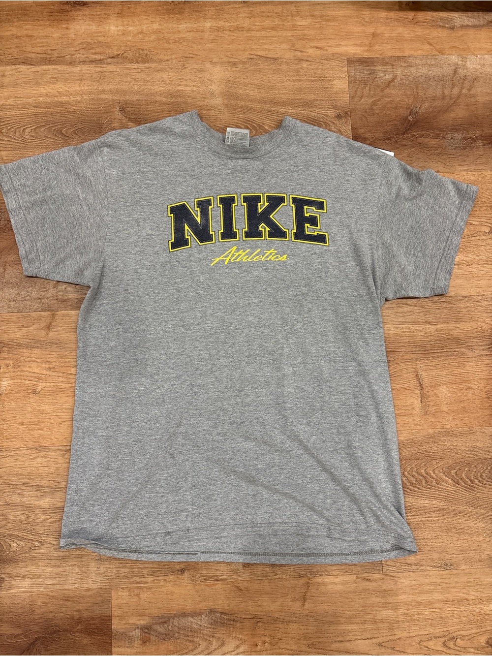 Nike Gray Short Sleeve 'NIKE Athletics' Graphic Tee with Yellow Accents